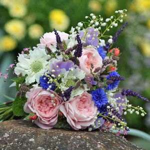 Summer bridal bouquet with cornflowers, peonies