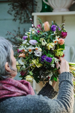 Rachel holding up bouquet whilst arranging